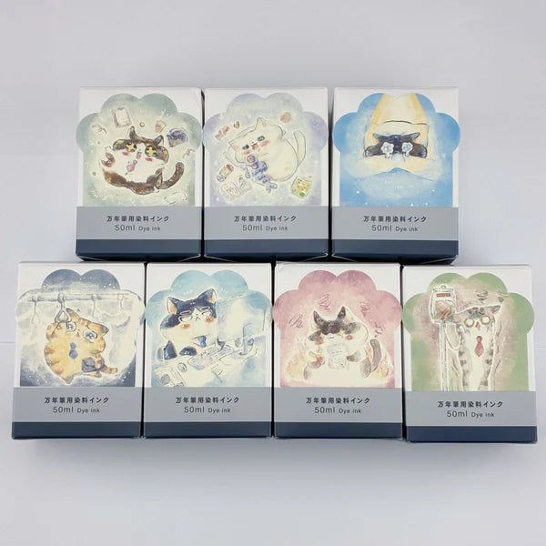 Set of seven ink packaging boxes with cat illustrations on a grey background