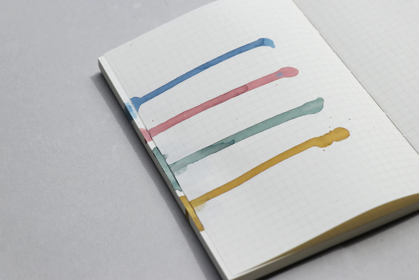 Notebook with terra ink colours on a grey background