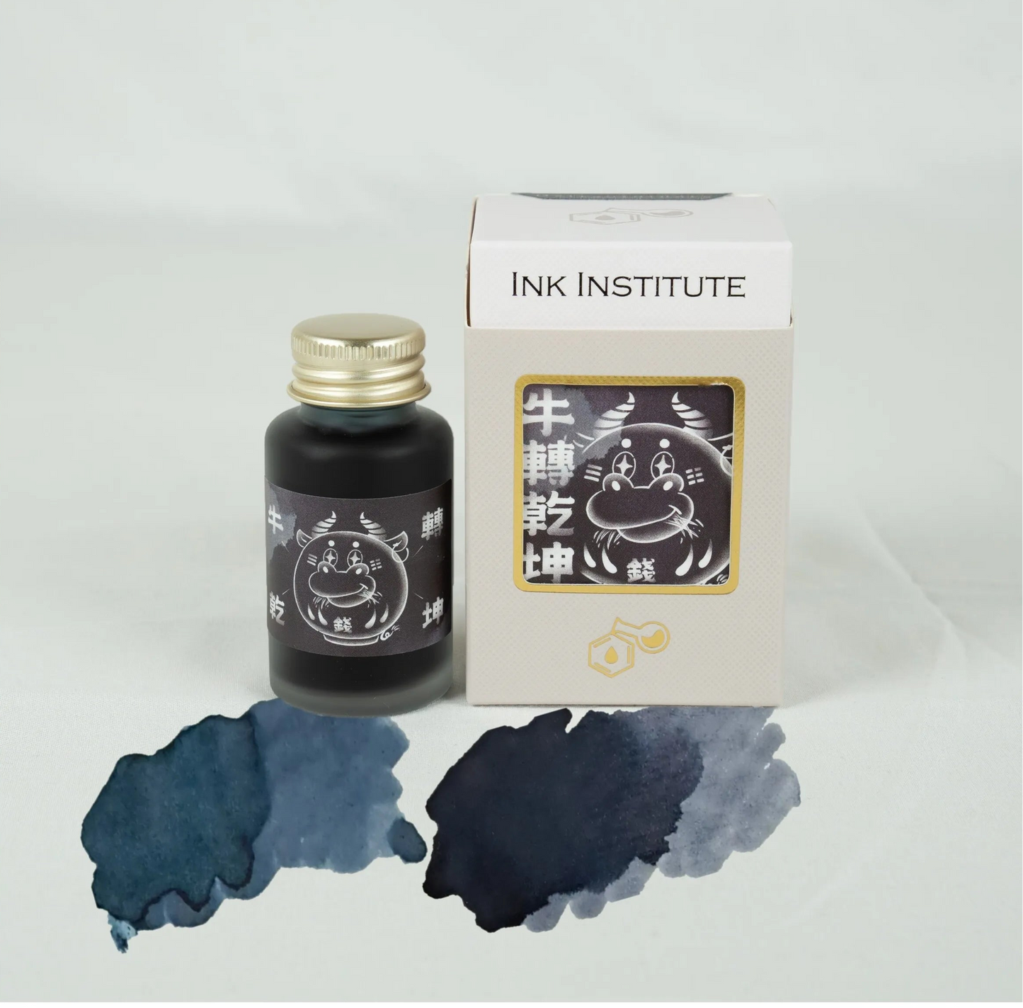 Ink bottle and packaging with 'Ink Institute' branding on a light gray background
