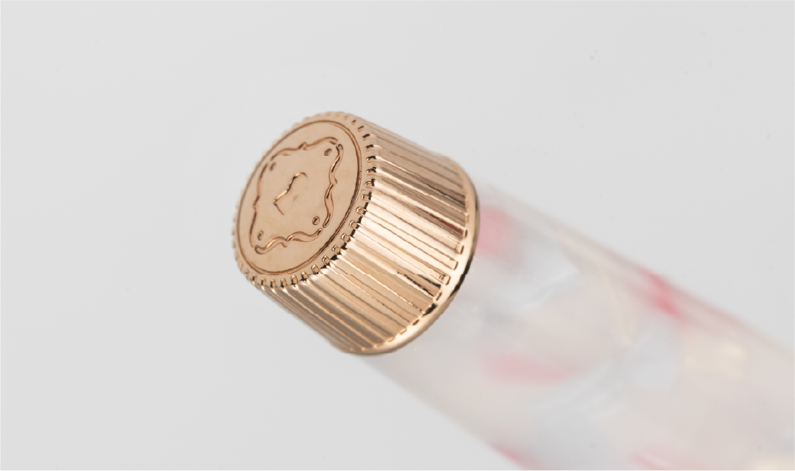 Close-up of a gold finial with a logo on a white background