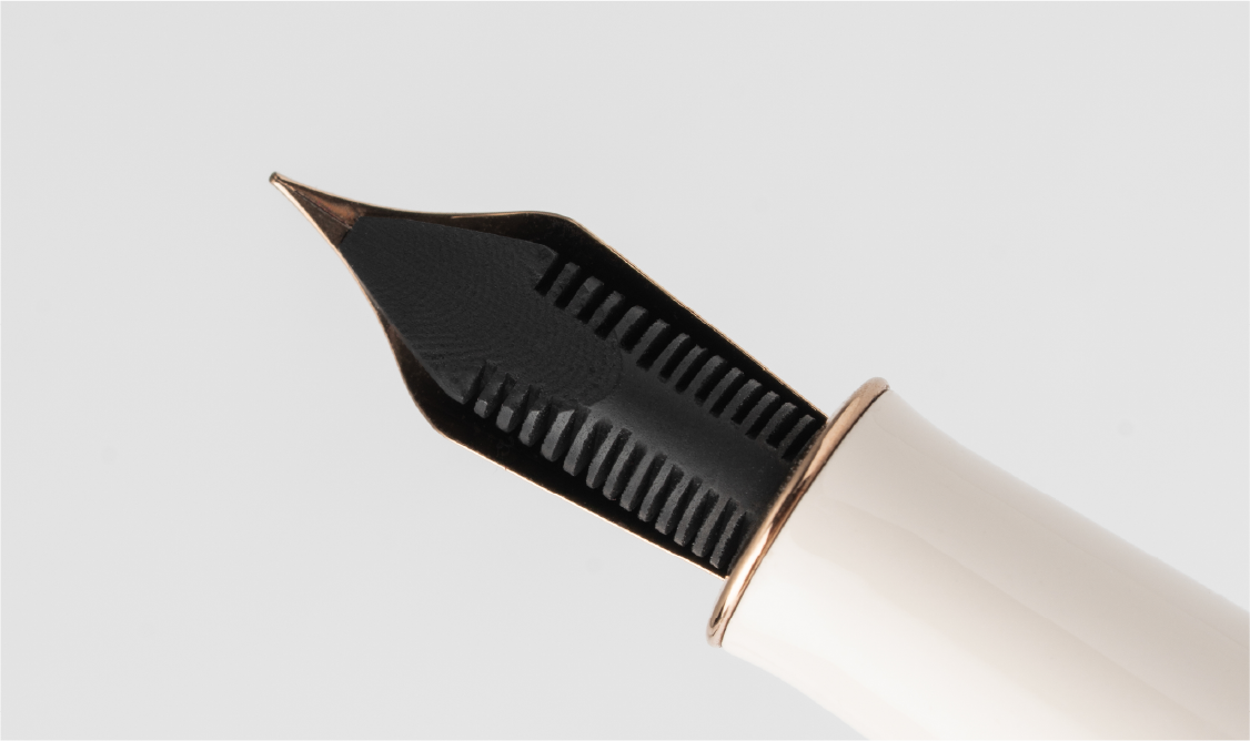 Close-up of a fountain pen ebonite feed on a white background