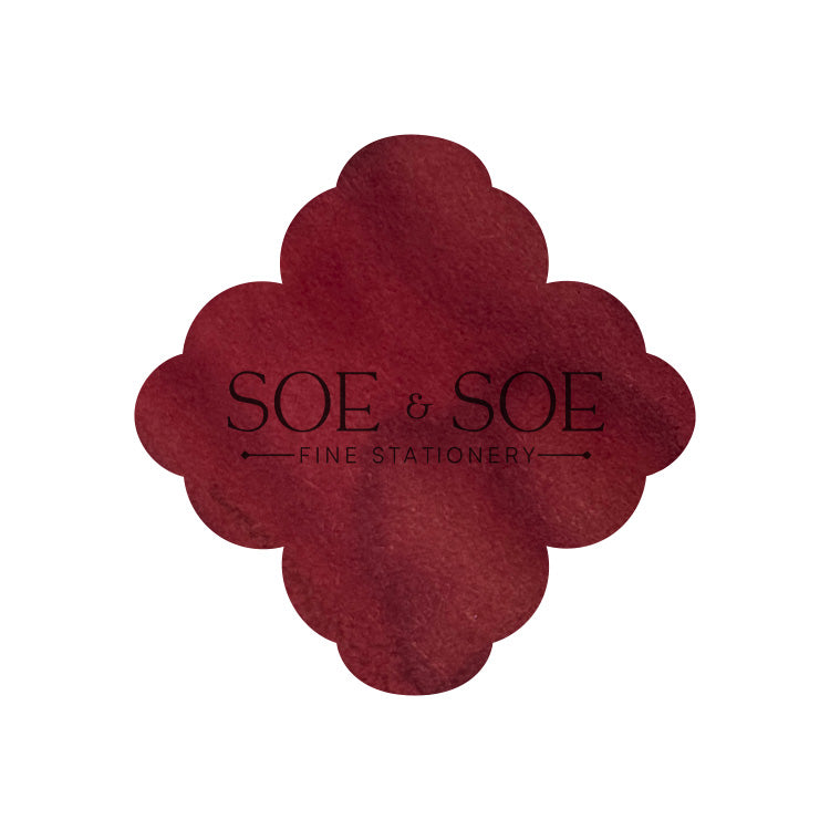 Red flower-shaped ink swatch with 'SOE & SOE Fine Stationery' text on a white background
