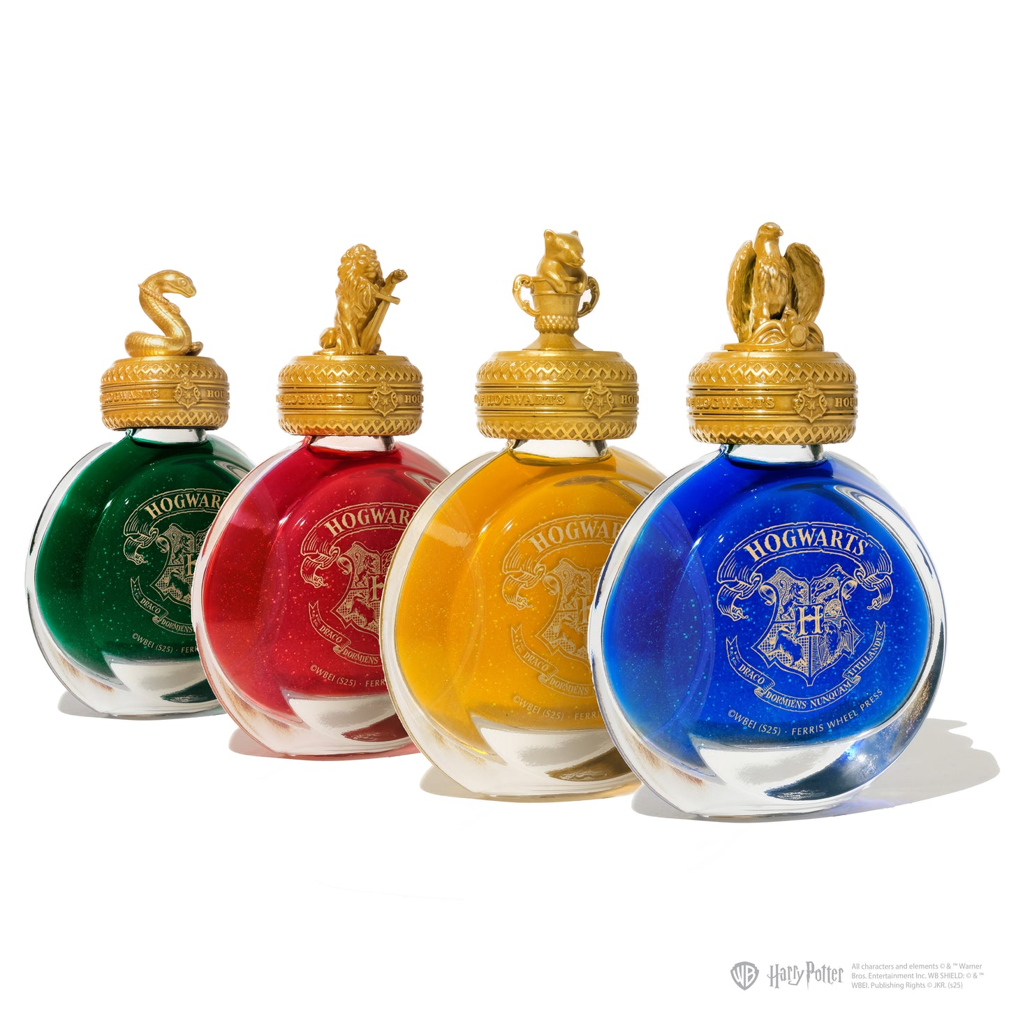 Four bottles of Hogwarts-themed ink with colored lids on a white background.