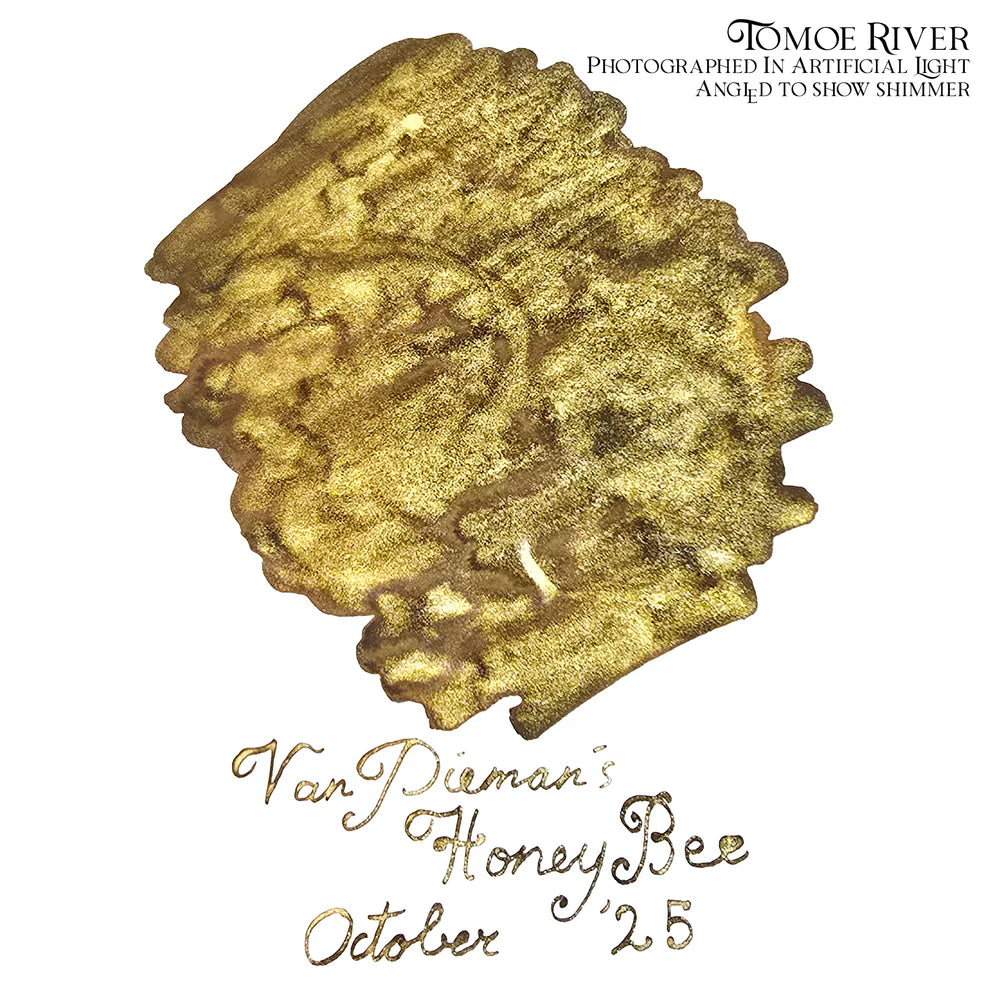 Gold-colored Van Dieman's Honey Bee ink swatch with text on a white background