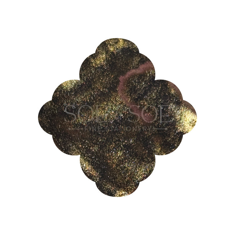 Black ink swatch with gold shimmer