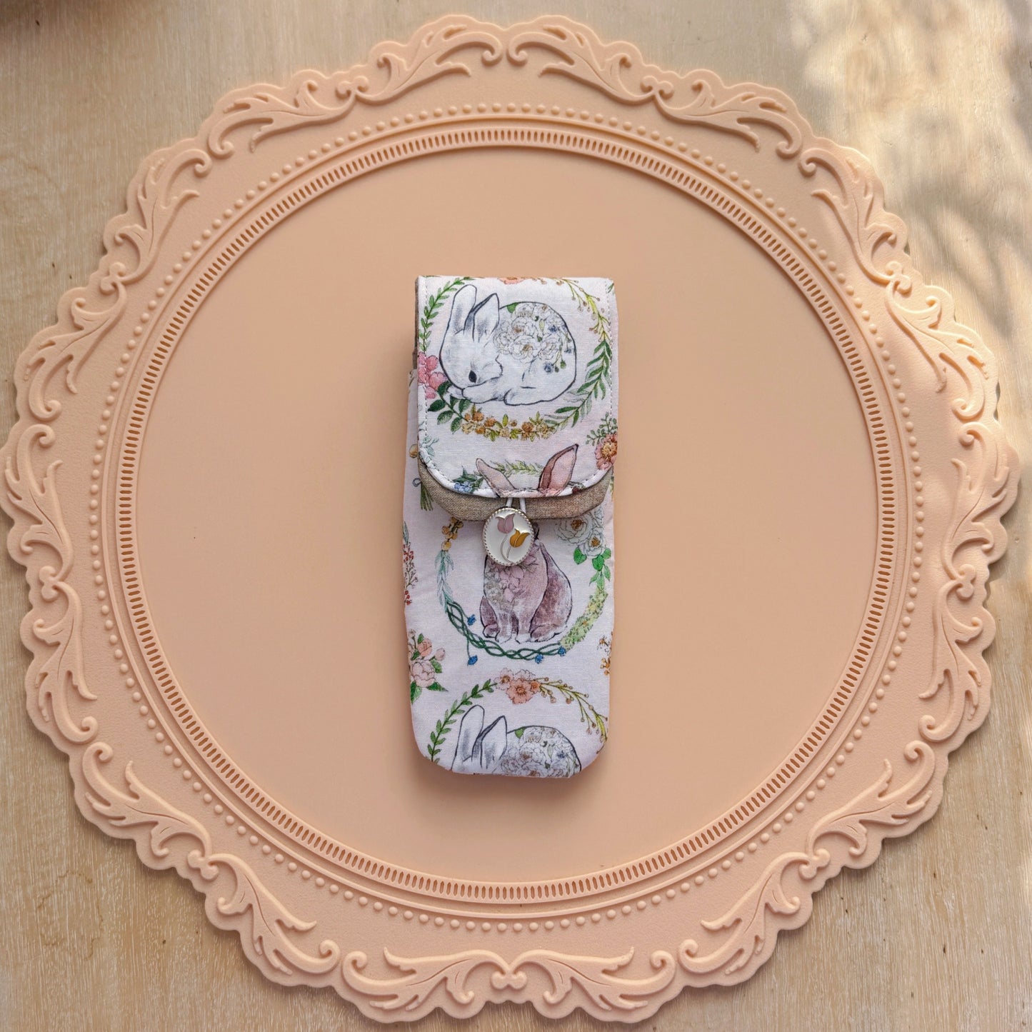 Decorative pen case with rabbit design on a decorative pink frame