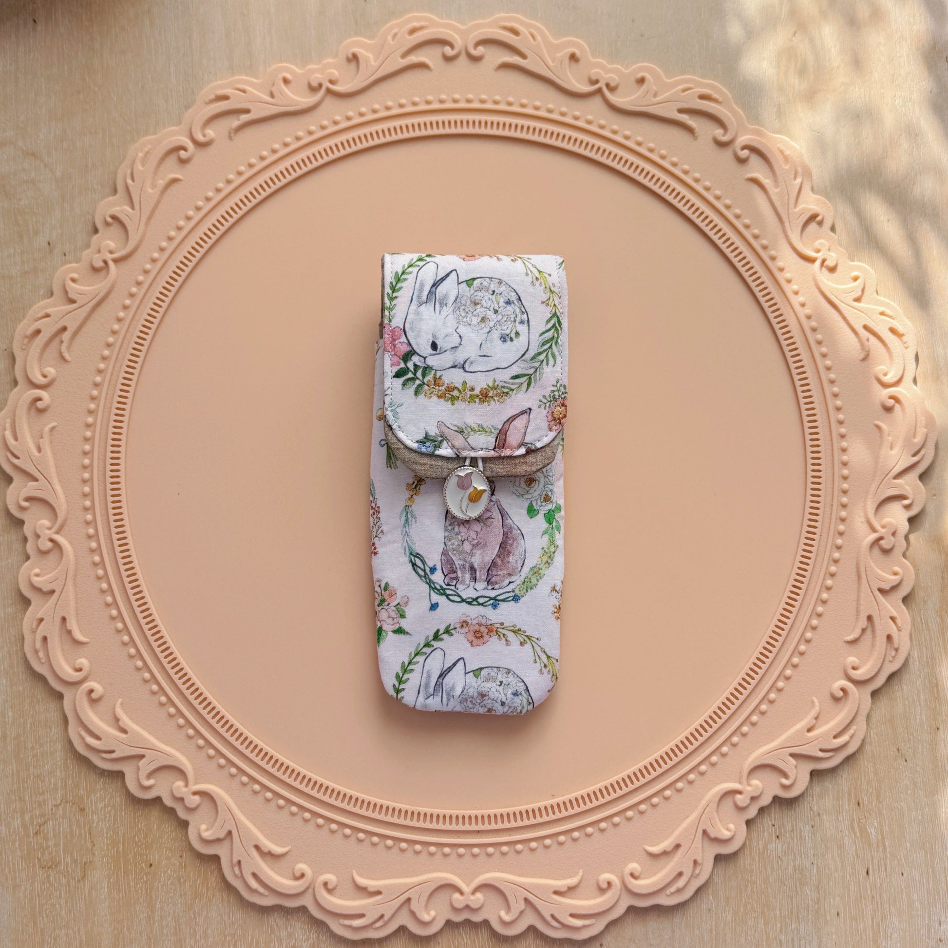 Decorative pen case with rabbit design on a decorative pink frame