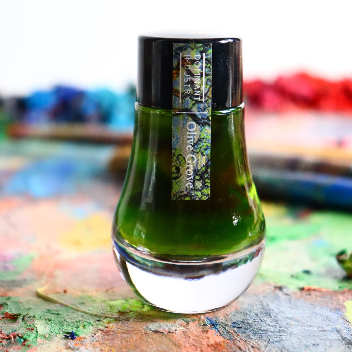 Dominant Industry Olive Grove ink bottle on a colourful background