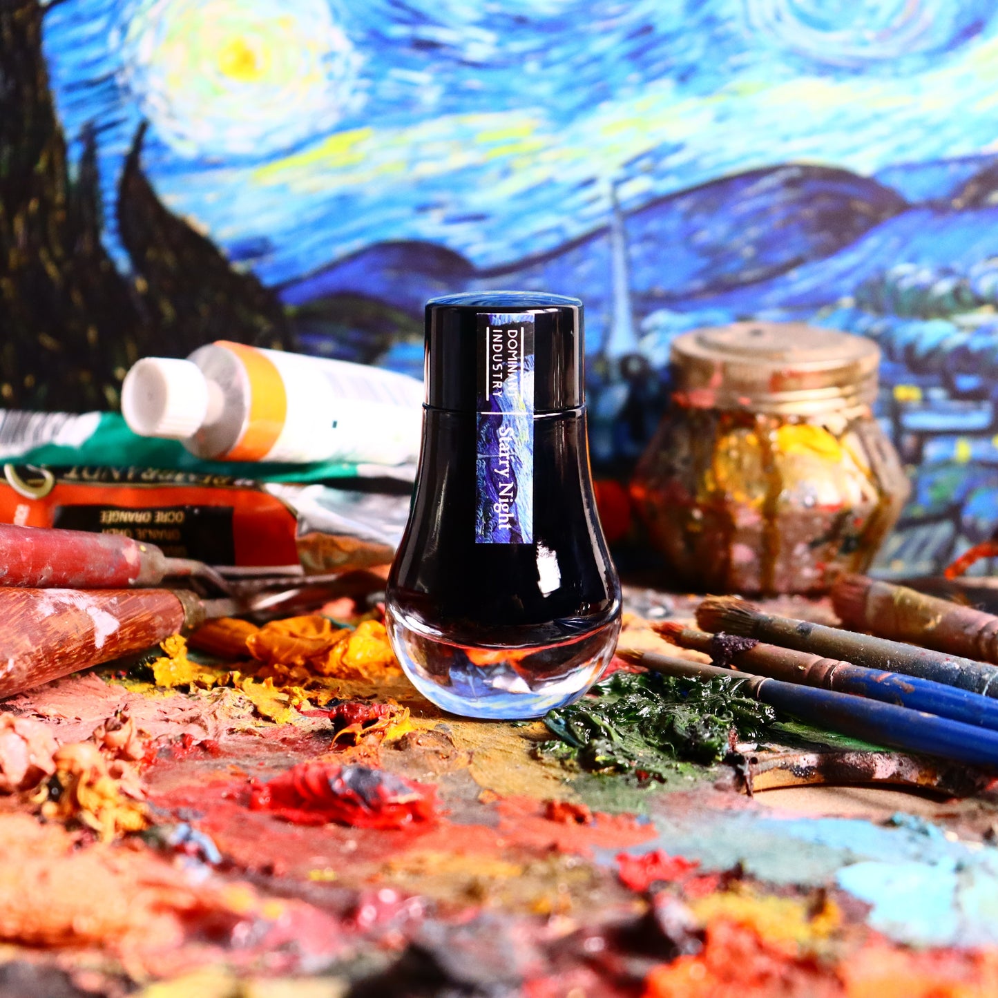 Dominant Industry ink bottle on an artist's palette with Van Gogh painting in the background