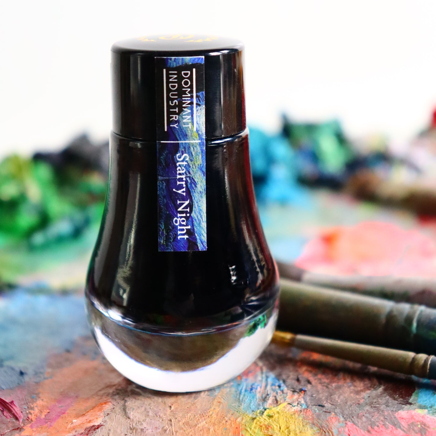 Ink bottle labelled 'Industry Dominant Starry Night' on a colourful background