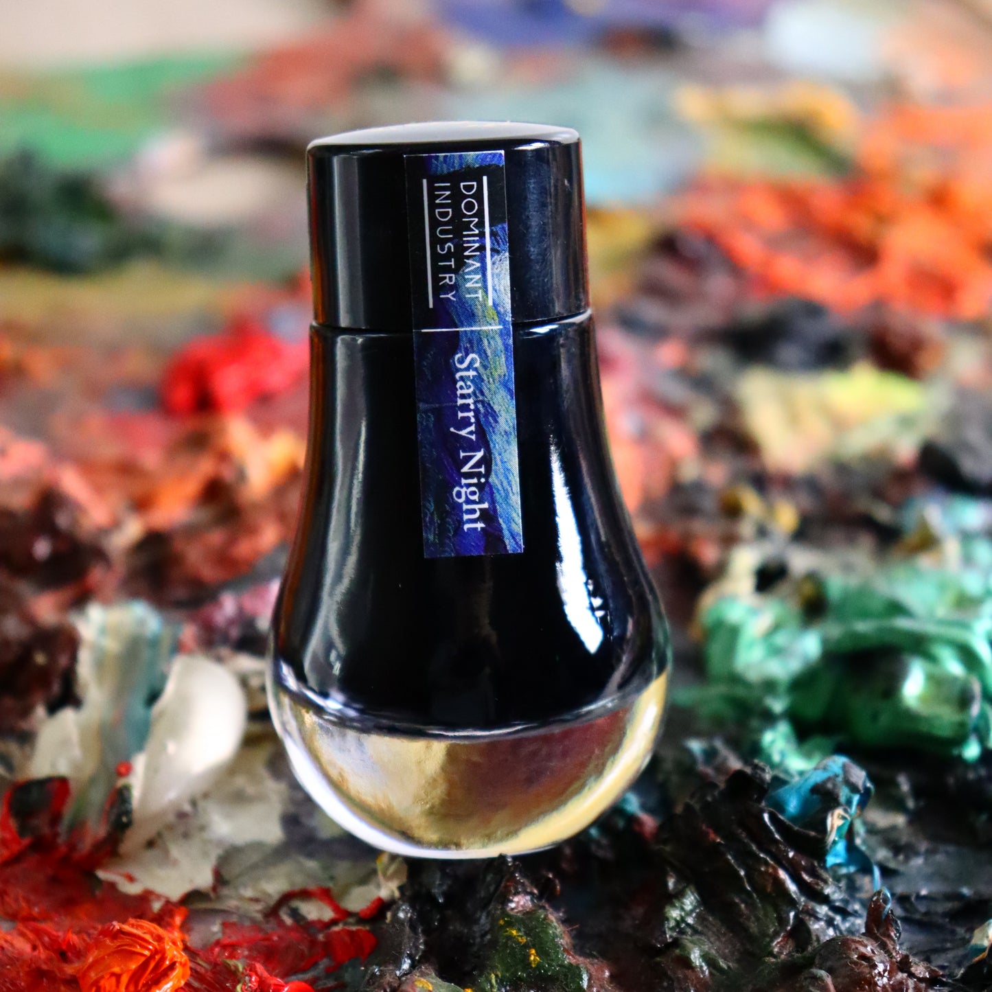 Ink bottle labelled 'Starry Night' on a colourful, abstract background
