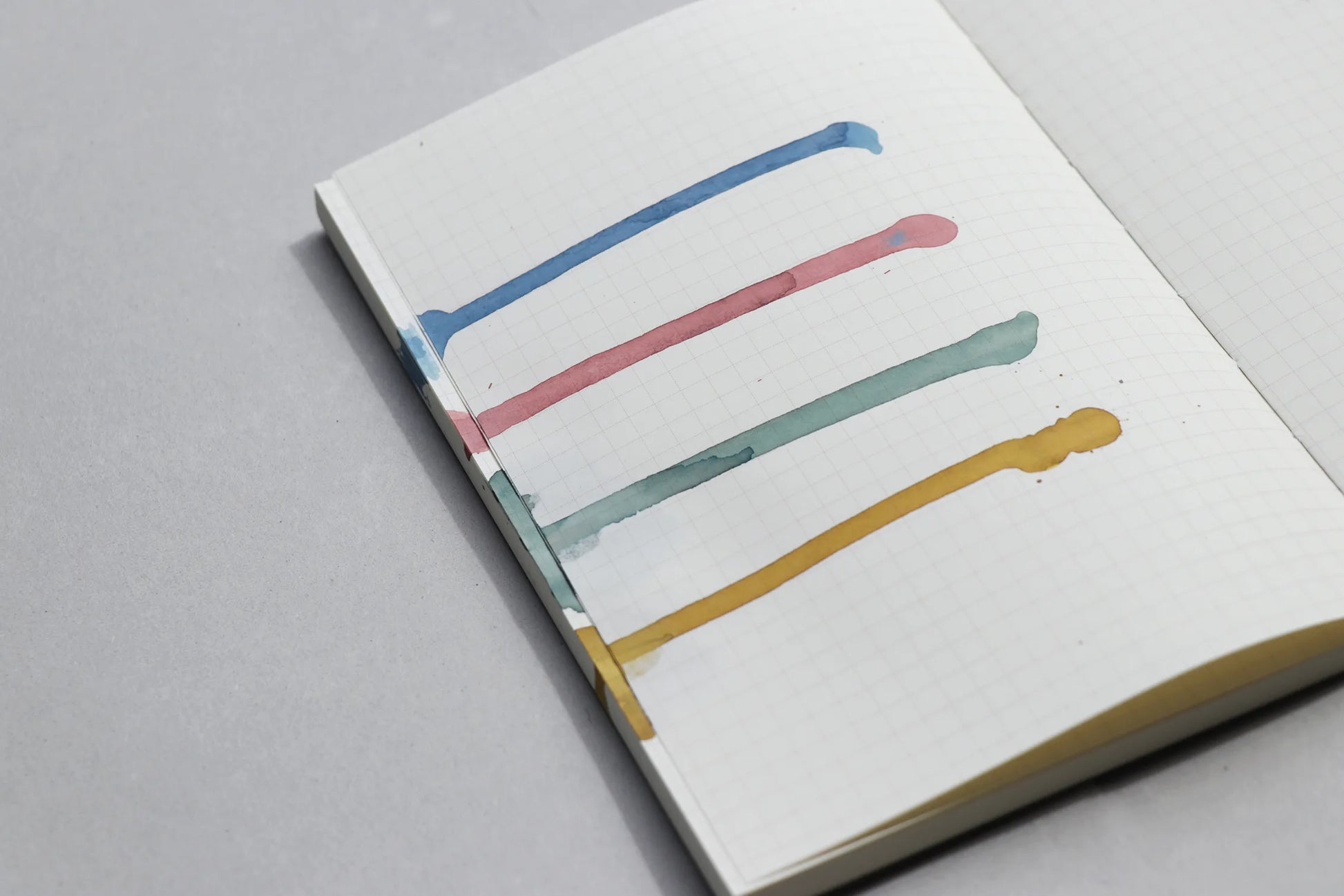 Notebook with terra ink colours on a grey background