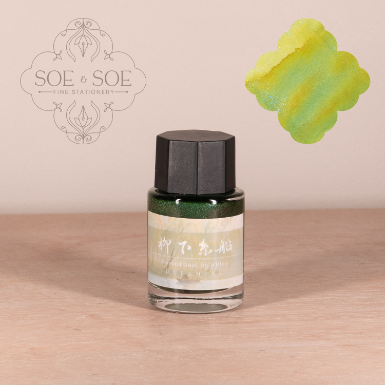 Dream Ink bottle with black cap and green label on a wooden surface, featuring SOE & SOE branding.