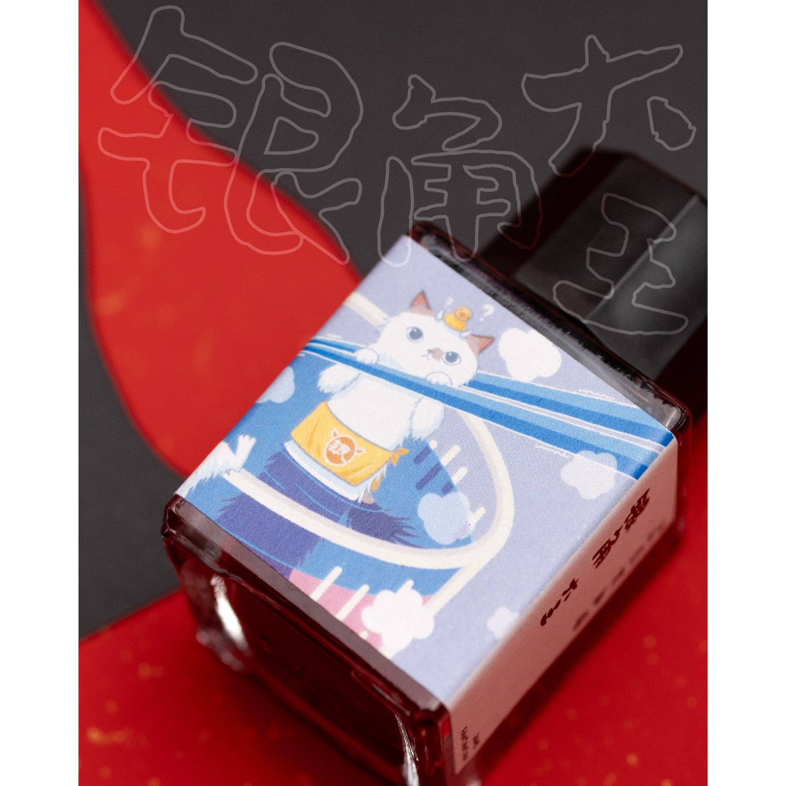 Ink bottle with a white cat on a red background
