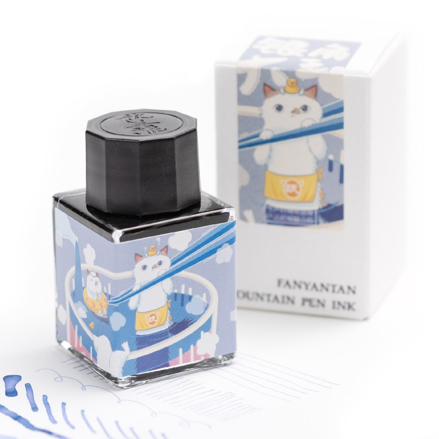 Fountain pen ink bottle with cat design and packaging on a white background
