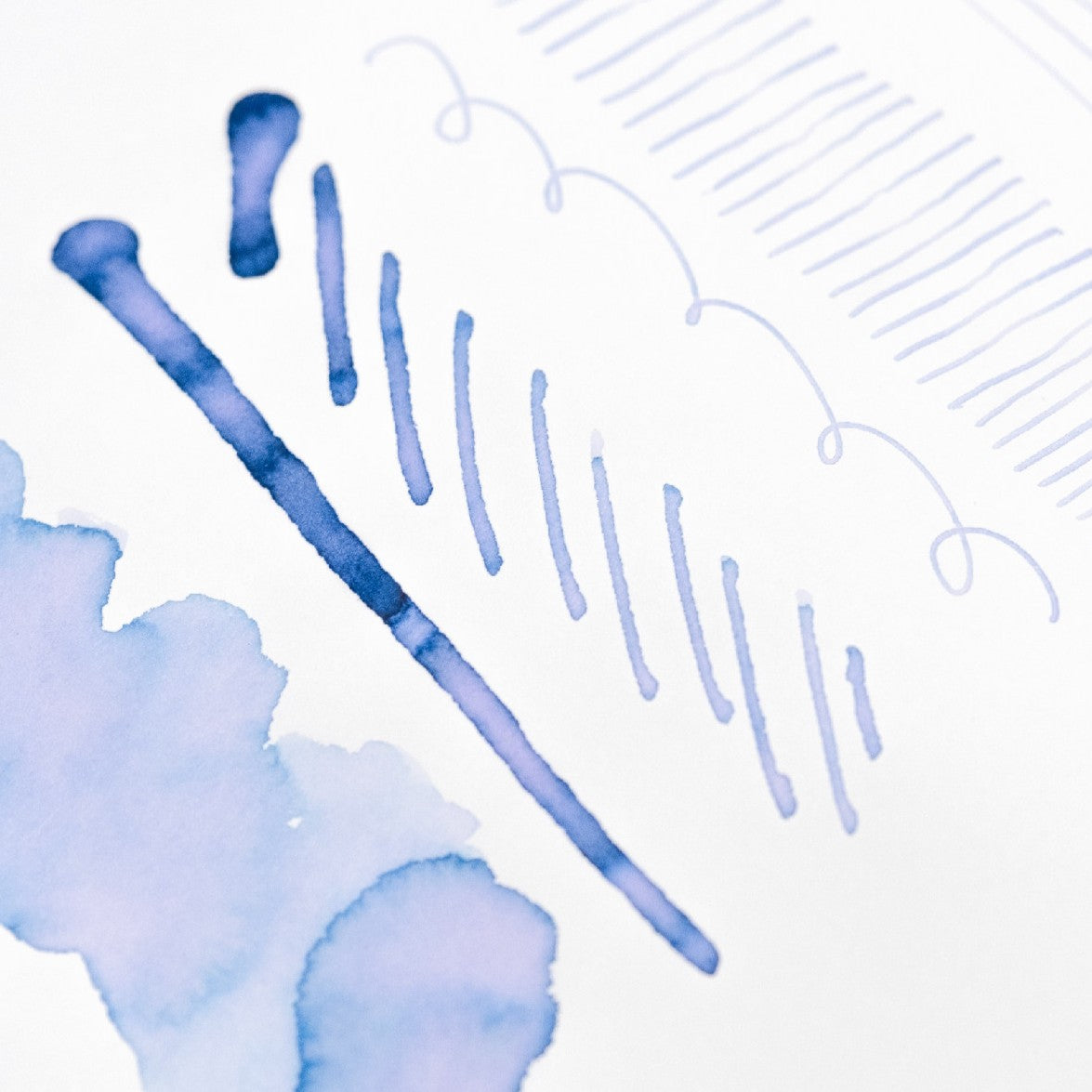 Blue ink brush strokes on a white background