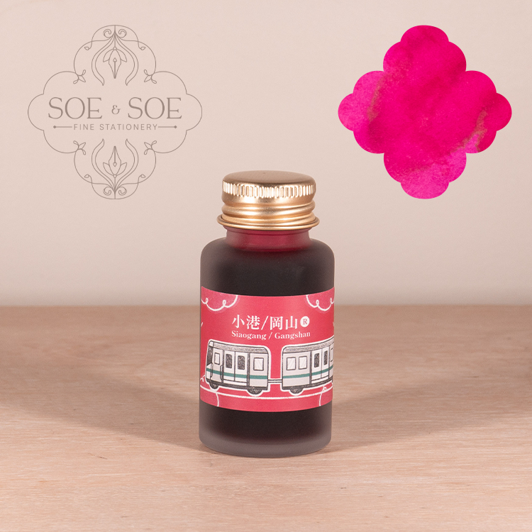 Ink Institute Pink Ink bottle with a pink label featuring train graphics on a wooden surface, with 'SOE & SOE' branding.