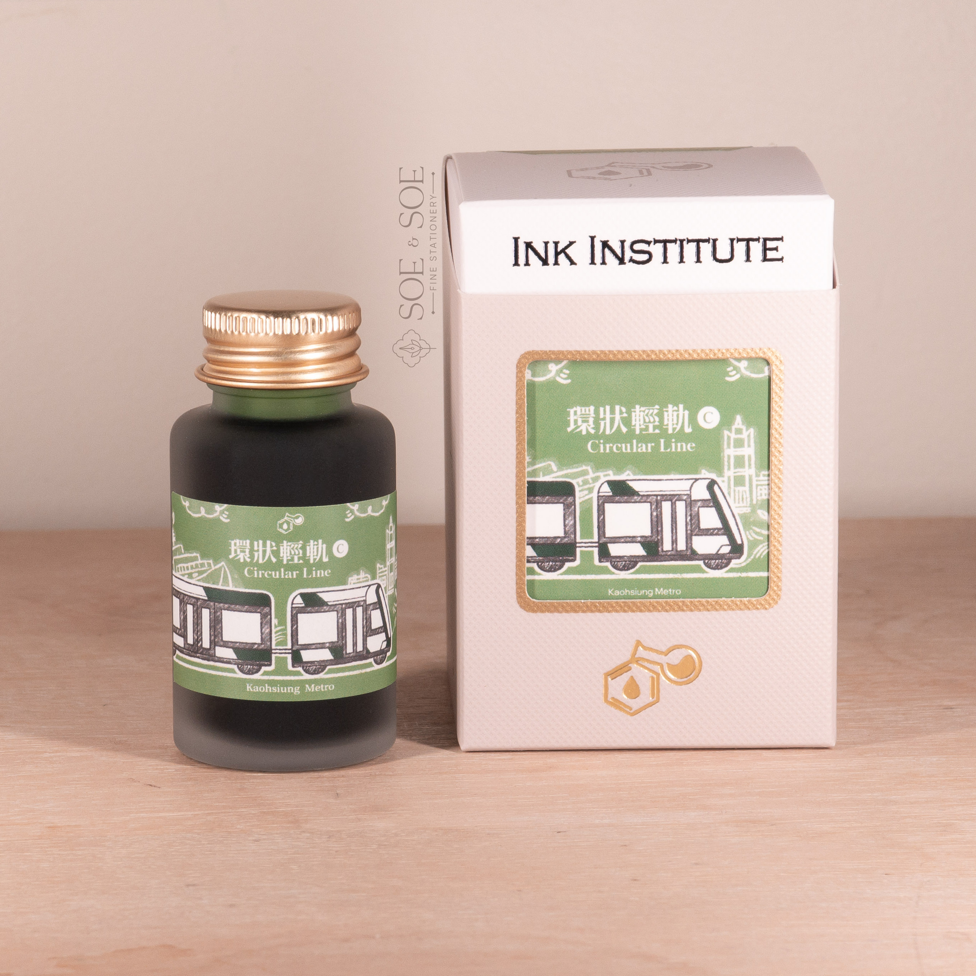 Bottle and packaging of Ink Institute product on a wooden surface