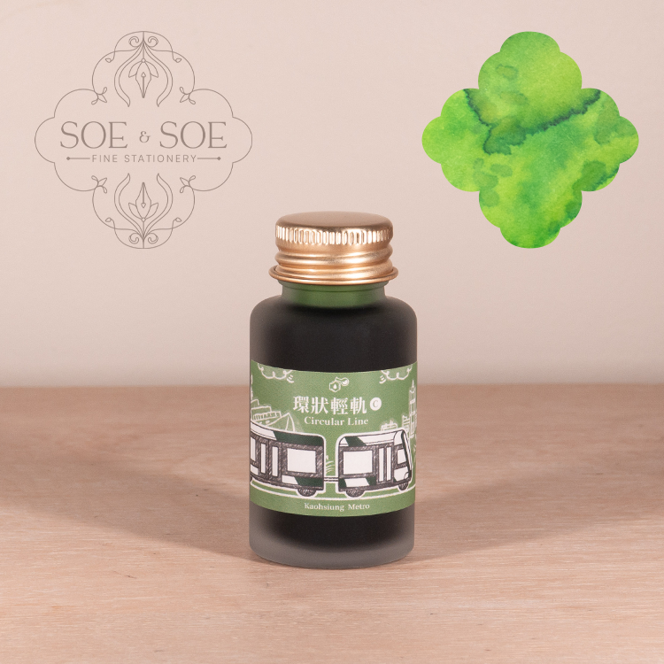 Ink Institute Circular Line ink bottle with green ink swatch on a wooden surface, featuring the SOE & SOE brand.