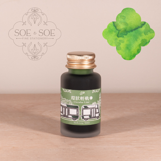 Ink Institute Circular Line ink bottle with green ink swatch on a wooden surface, featuring the SOE & SOE brand.
