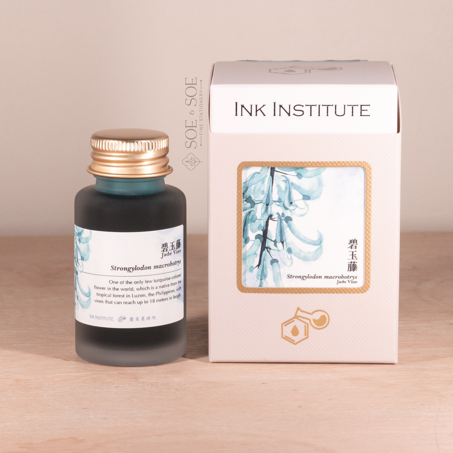 Bottle and box of Ink Institute product on a wooden surface with a beige background