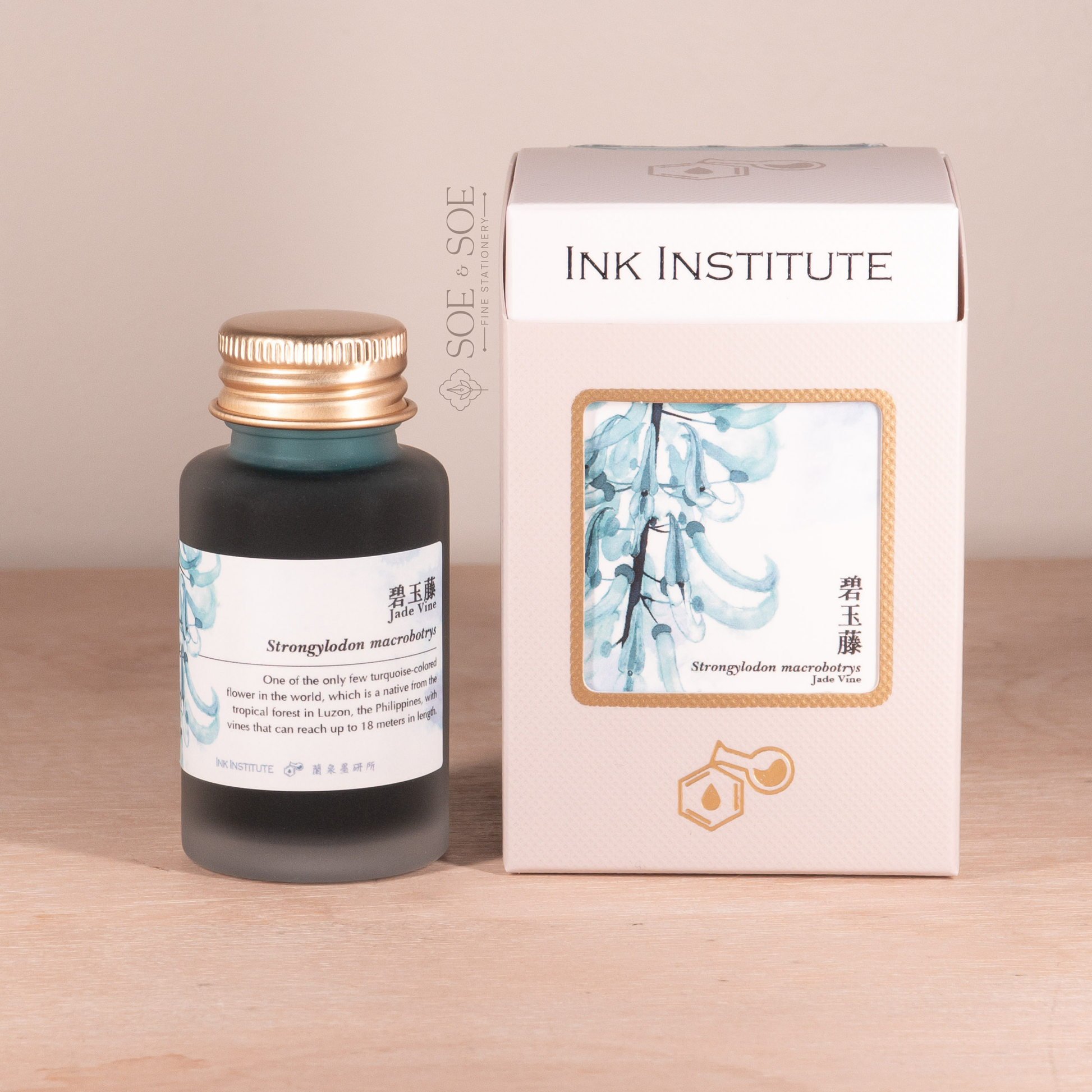 Bottle and box of Ink Institute product on a wooden surface with a beige background