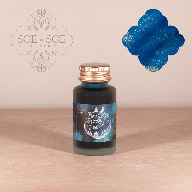 Bottle of Ink Institute ink with a dragon design on a wooden surface, featuring the SOE & SOE brand.