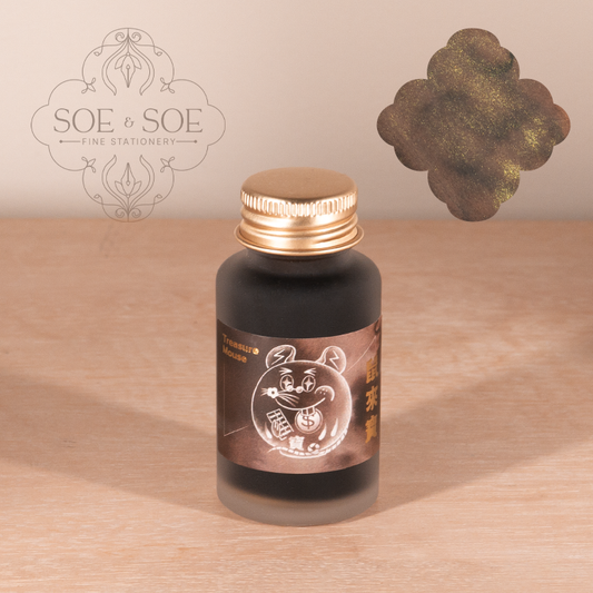 Ink Institute Ink bottle with gold cap on a wooden surface, featuring the 'SOE & SOE' brand.