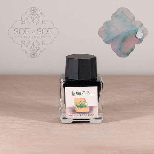Ink bottle with label illustration on a wooden surface, featuring 'SOE & SOE' branding.