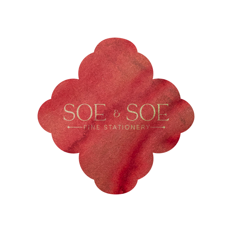 Red flower-shaped ink swatch with 'SOE & SOE Fine Stationery' text on a white background