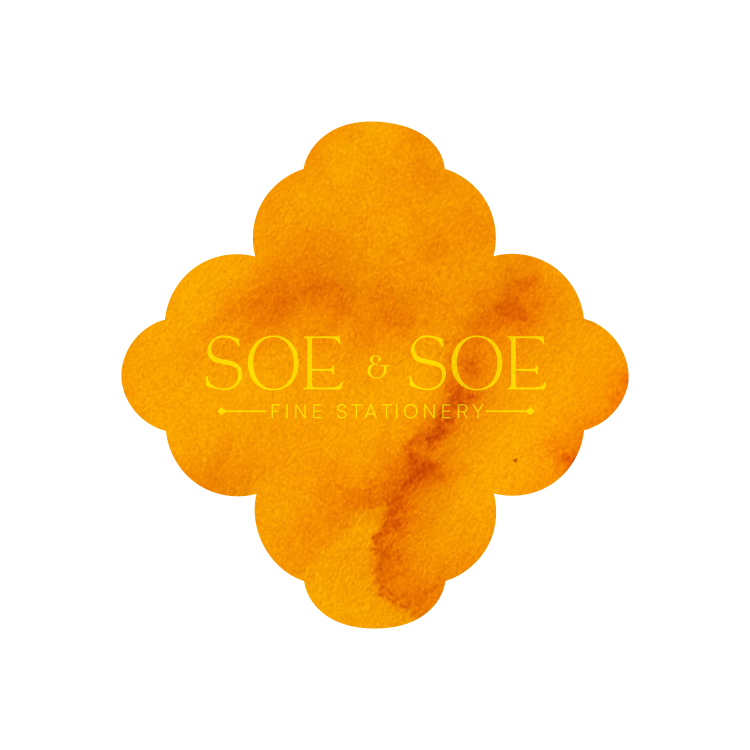 Golden Toad ink swatch in the shape of the logo of SOE & SOE Fine Stationery  on a white background